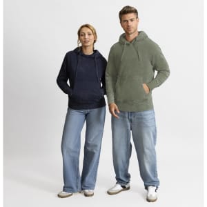 A navy and olive green hoodie worn by a woman and a man, featuring a front pocket and hood. Both model relaxed denim jeans.