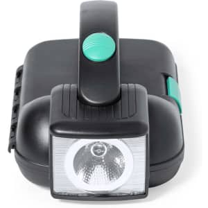 A black portable work light with a green handle and button, featuring a bright front light.