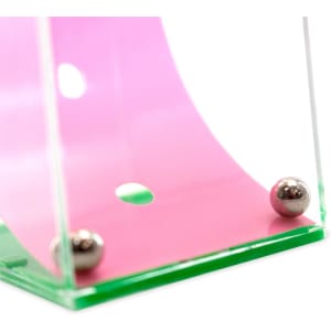 A transparent game display featuring a pink curved track and two silver balls at the base.