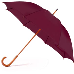 A burgundy umbrella with a wooden handle and a curved grip, featuring a logo.