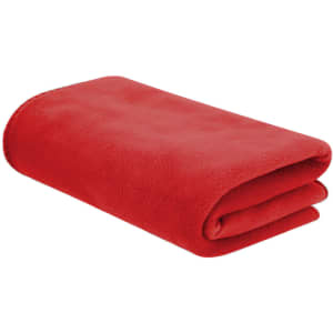 A folded red blanket lies flat, made from soft fleece material, featuring a simple design and a subtle logo.