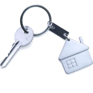 A silver keyring featuring a house-shaped charm and a key attached to it.