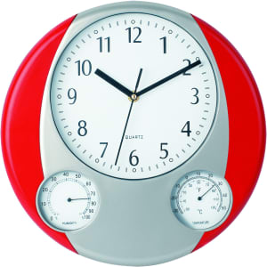 A round wall clock with a red frame, featuring black hour and minute hands, and gauges for humidity and temperature.