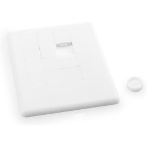 A white mini puzzle featuring nine square pieces with one piece removed, plus a circular piece nearby.