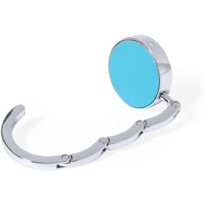 A foldable bag hanger in silver with a turquoise circular top. Features a sleek, compact design.