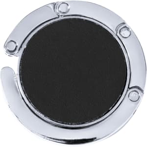 A circular chrome bag hanger with a black centre, featuring a metal loop and a polished finish.