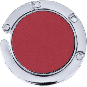 A foldable bag hanger in silver with a red circular surface and a shiny finish, featuring a logo.