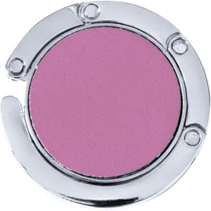 A foldable bag hanger in silver with a round pink surface. It has a sleek, metallic design.