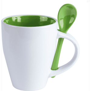 A white coffee mug with a green interior and matching spoon attached to the handle.