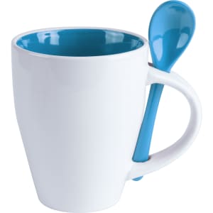 A white coffee mug with a blue interior and a matching spoon attached to the handle.