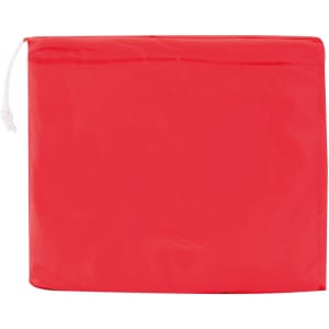 A red poncho stored in a compact bag, featuring a drawstring closure and a logo on the pouch.