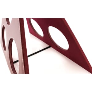 A wine rack in maroon, featuring circular cutouts, with a black support at the base. It has a sleek design and branding.