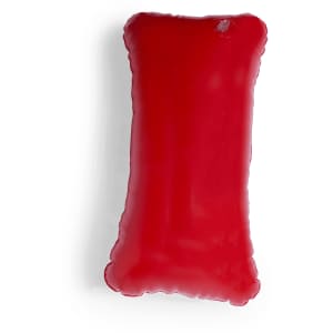 A bright red Cancún Pillow with a soft, smooth surface, featuring a rounded edge design. It has a logo.