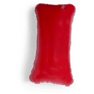 A bright red inflatable pillow with a rectangular shape and smooth surface, featuring a small logo.