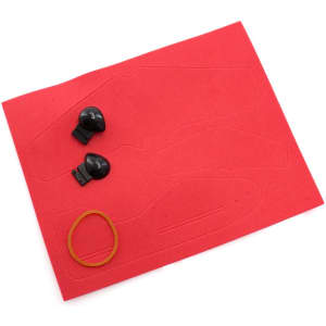 A red sheet with cut-out shapes, two black ear pieces, and a yellow rubber band, designed for a novelty item.