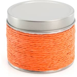 An orange woven candle in a silver tin container with a flat lid.