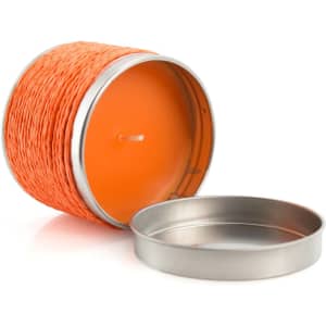 An orange aromatic candle in a metal holder, featuring a removable lid. The candle has a woven texture.