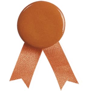 A lapel pin in an orange hue with a round top and two trailing ribbons. It features a logo.