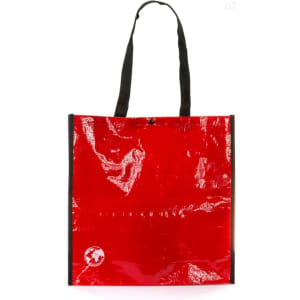 A red reusable grocery bag with black handles, featuring a logo on the lower corner.