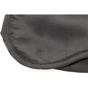 A soft, grey travel eye mask with a smooth texture and stitched edges. It features a logo.