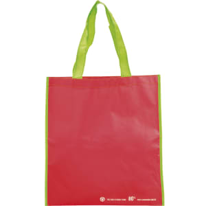 A red tote bag with green handles and a logo on the side. It's made from durable material.