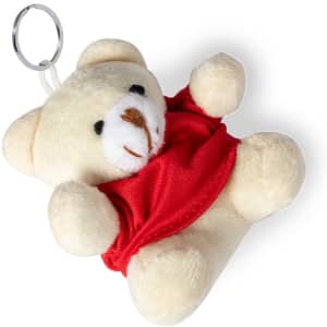 A cream teddy bear keyring wearing a red outfit, complete with a silver keyring attachment.