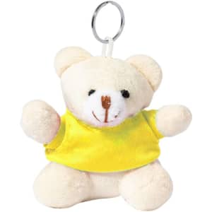 A plush teddy bear keyring in cream with a bright yellow shirt and a metal keyring attached.