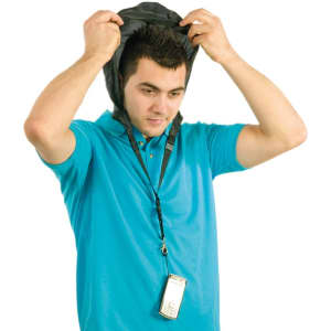 A man in a blue polo shirt is placing a black lanyard over his head, which holds a device. The lanyard has a logo.
