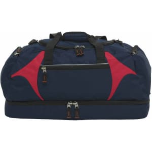 A navy blue duffle bag with red accents, featuring multiple zippered compartments and sturdy black handles.