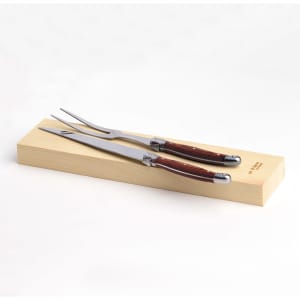 A stainless steel carving set with wooden handles, resting on a wooden presentation box.