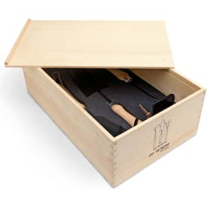 A wooden garden box with various gardening tools inside and a fitted black foam insert for protection.
