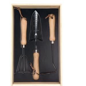 A set of three garden tools with wooden handles, housed in a wooden box with a black interior.