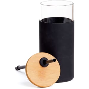 A drink bottle featuring a clear glass body, black silicone sleeve, and a bamboo lid with a straw.