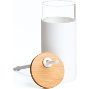 A drink bottle featuring a white body, clear glass top, and a wooden lid with a white straw. It has a logo.