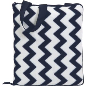 A patterned outdoor blanket featuring a navy blue and white zigzag design, with carry handles and a zip closure.