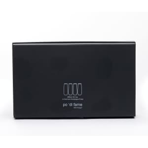 A black box containing stemless champagne flutes, featuring a simple logo. The flutes are made of glass.