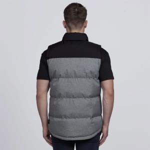 A puffa vest in grey and black with a branding logo, featuring a padded design and a collar.