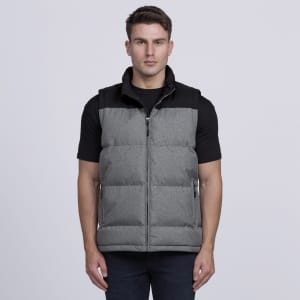 A man wearing a grey puffer vest with a black top. The vest features a zip and side pockets.