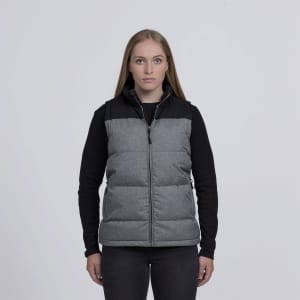 A grey and black puffa vest with a zip front and a logo, displayed on a model against a plain background.