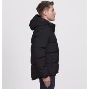 A black puffer jacket with a hood, featuring zippers and a logo, displayed on a male model from the side.