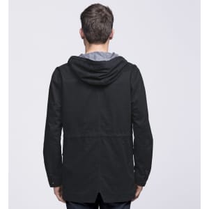 A black twill jacket featuring a hood and a stylish cut, shown from the back. It has a logo on the back.