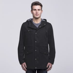 A black twill jacket featuring a hood and multiple pockets, with a grey lining. Includes branding.