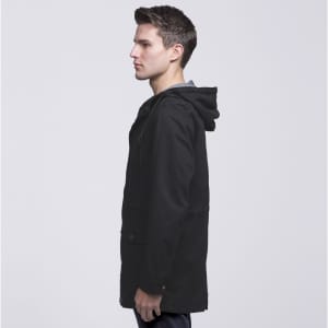 A black twill jacket featuring a hood, displayed on a model from the side, with a logo visible on the garment.