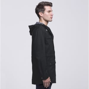 A black Heritage Twill Jacket with a hood, featuring a side view of a model wearing it.