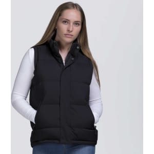 A black puffa vest with a high collar and side pockets, worn by a model against a plain background.