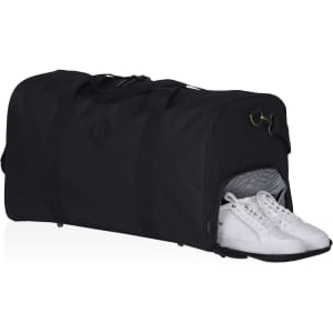 A black duffle bag with a separate compartment for shoes, featuring a logo.