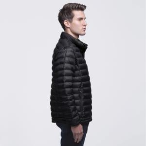 A black puffer jacket with a zip closure and a high collar, featuring a logo. Model displayed in profile.