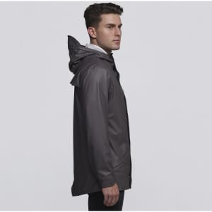 A man in a grey rain jacket with a hood stands sideways, displaying the jacket's sleek design and fit.