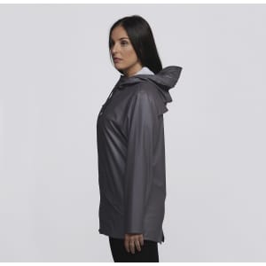 A woman wearing a grey rain jacket with a hood, featuring a logo on the front.