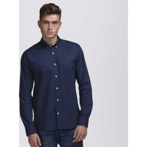 A navy blue button-up shirt with a collar and a chest pocket, modelled by a man. Features branded labels.